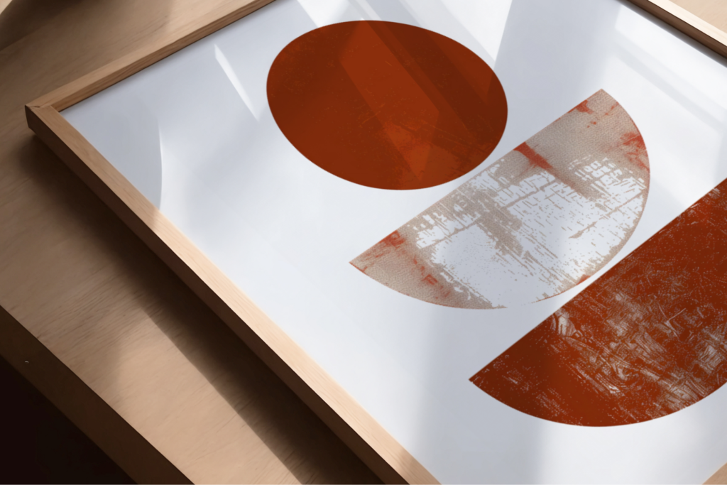 Minimal geometric art with rust-red circle and semicircles in wooden frame.