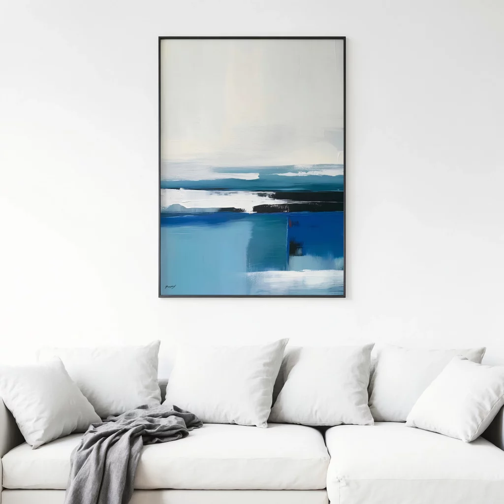 Abstract blue coastal artwork hanging above white sofa in modern gray living room