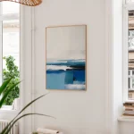 Abstract blue ocean painting in minimalist interior with plant and wooden bookshelf.