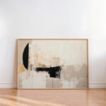 Abstract artwork with neutral tones and bold black forms in wooden frame.