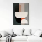 Abstract geometric artwork in black and terracotta tones above white minimalist sofa.