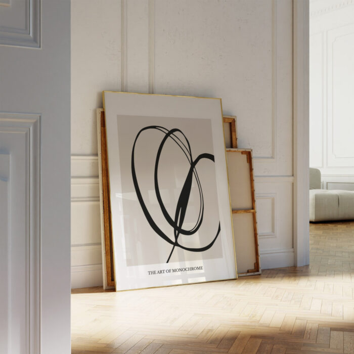 Elegant black brushstroke abstract print leaning against white wall in minimalist interior space.