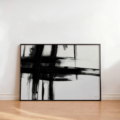 Abstract black brushstrokes on white canvas in minimalist frame against neutral wall.