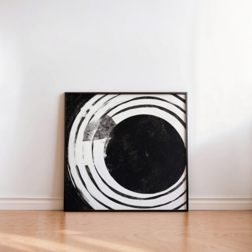 Minimalist black circle artwork with dynamic white swirls against neutral wall.