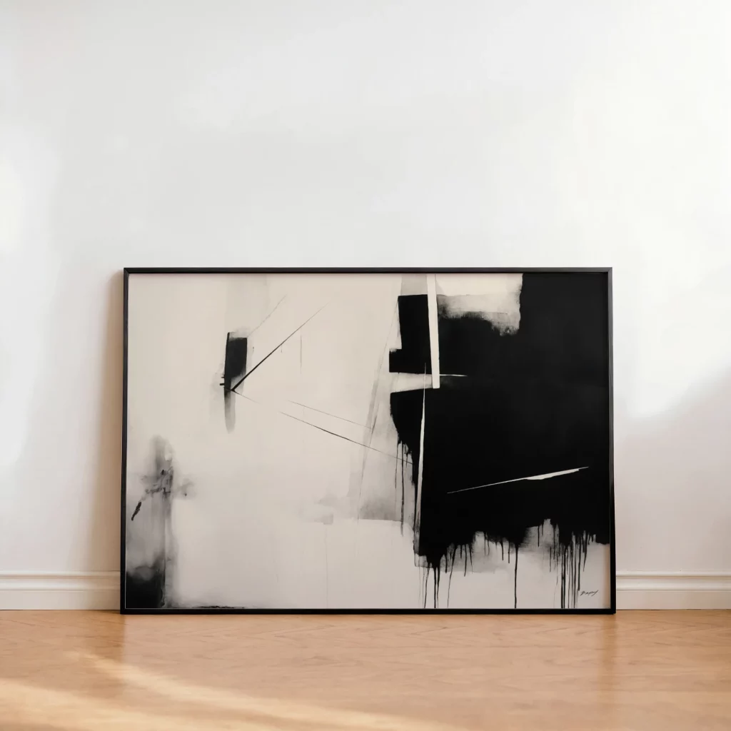 Abstract black and white painting with bold brushstrokes displayed against white wall on wooden floor.