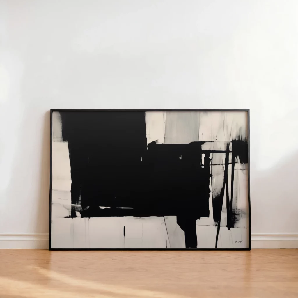 Bold black brushstrokes on white canvas in minimalist black frame against white wall.