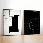 Two minimalist abstract artworks in black and white geometric patterns with thin black frames.