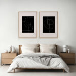 Abstract line drawings in black frames above minimalist bedroom with neutral bedding.