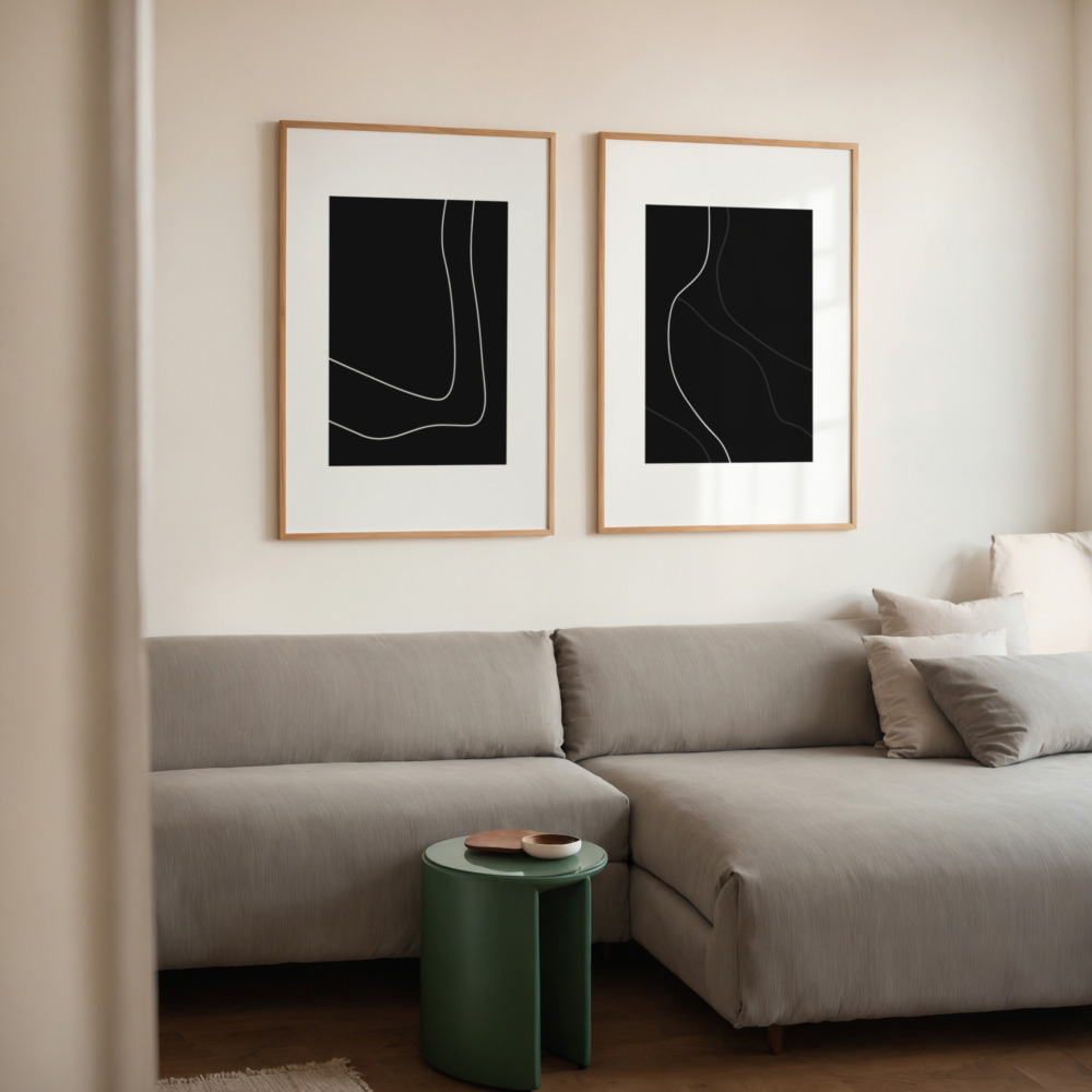 Minimalist line art prints in black frames above gray sectional with green accent table.