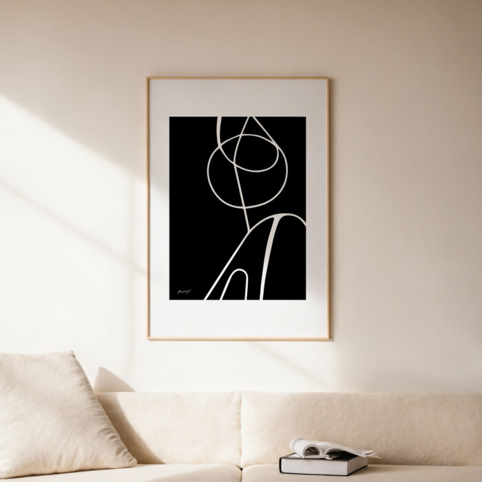 Minimalist black and white abstract art with curved lines mounted above a neutral sofa.