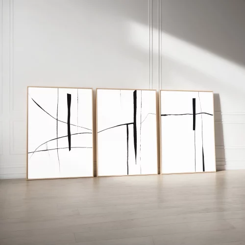 Black and white minimalist line art triptych leaning against white wall.