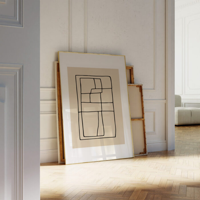 Minimalist black and beige line drawing leaning against white wall over herringbone wood flooring.