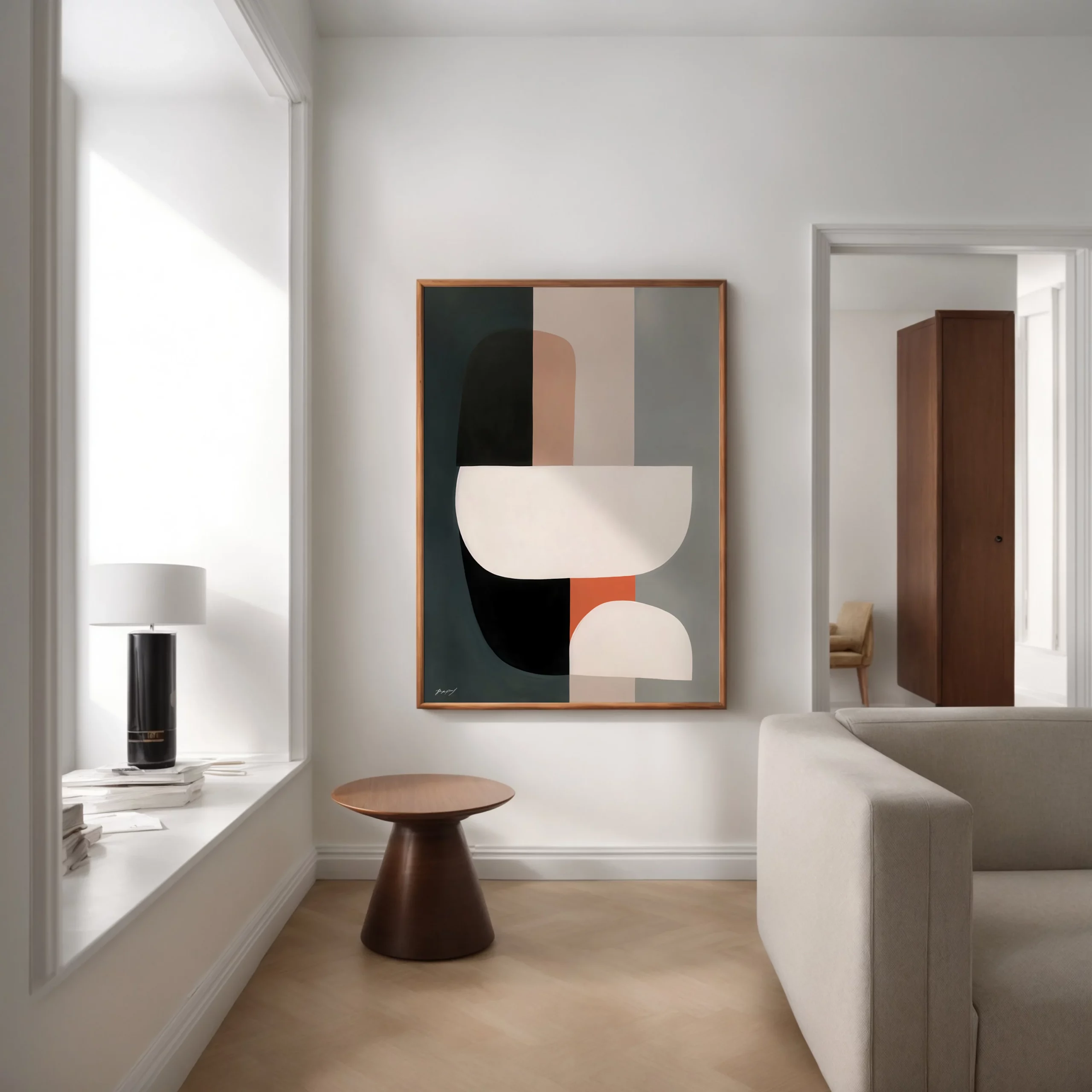 Minimalist living room with geometric wall art, natural light and modern furnishings.