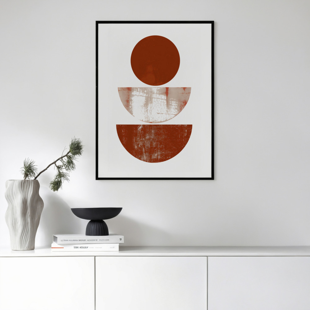 Minimalist terracotta circle art print above sleek white cabinet with decorative objects.