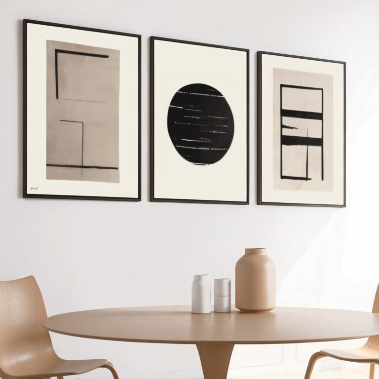 Minimalist abstract triptych artwork displayed above round wooden dining table with ceramic vessels.