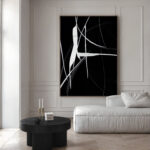 Abstract black and white artwork with flowing lines in a minimalist contemporary space