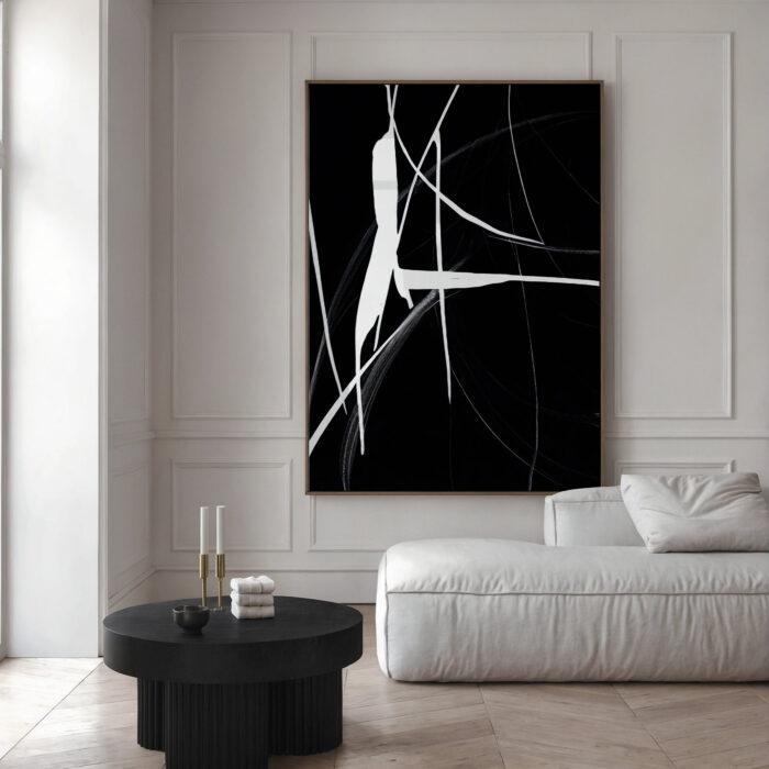 Abstract black and white artwork with flowing lines in a minimalist contemporary space