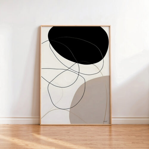 Abstract black geometric art print in wooden frame against white wall