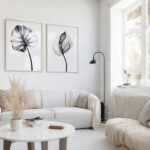 Minimalist black and white botanical prints in elegant white living room with modern furniture.