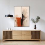 Abstract painting displayed above wooden credenza with pendant light and minimalist styling