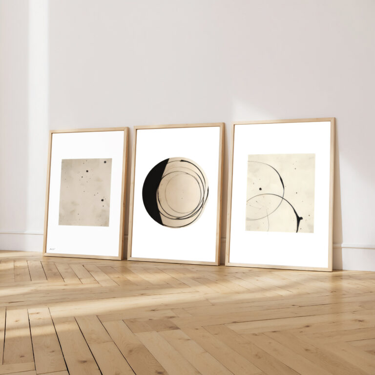 Minimalist abstract triptych with geometric shapes in light wooden frames against white wall.