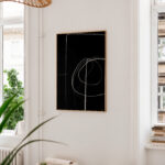 Minimalist black and white abstract art with circular lines in wooden frame