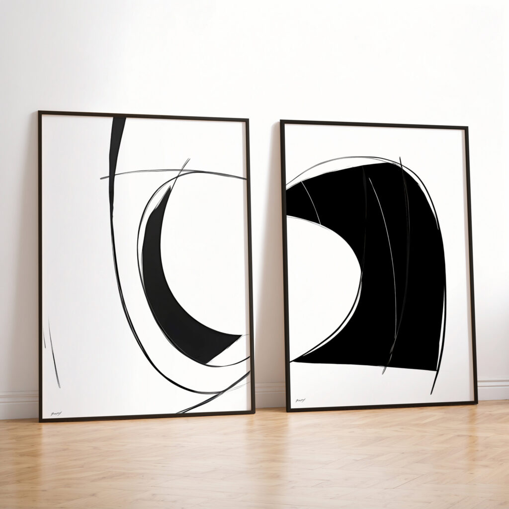 Minimalist black and white abstract diptych with curved lines leaning against white wall.