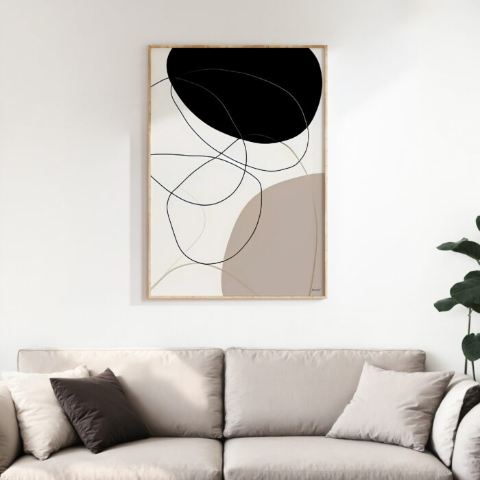 Minimalist abstract wall art with curved black and beige lines above neutral sofa.