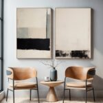 Minimalist abstract wall art with caramel leather chairs and decorative branches
