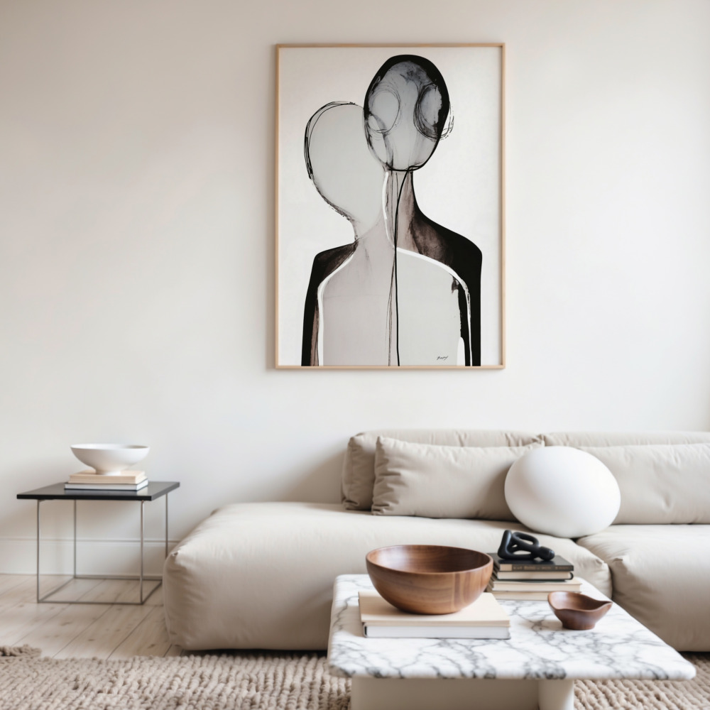 Minimalist living room with black and white abstract art above cream sofa