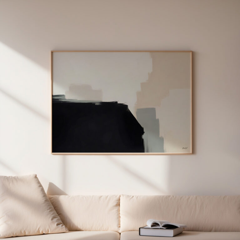Abstract black and white artwork hanging above cream sofa in minimalist living room.