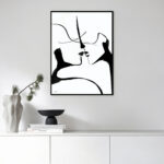 Minimalist black and white line art showing two abstract faces, elegantly framed above modern decor.