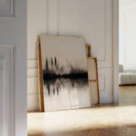 Abstract forest reflection artwork leaning against white wall in minimalist interior space
