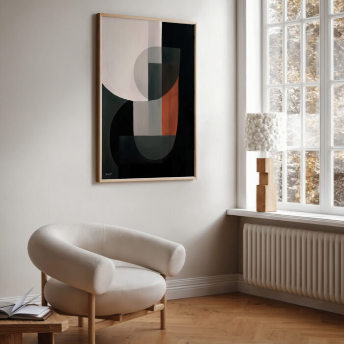 Abstract artwork hanging above cream armchair in minimalist interior with natural light.