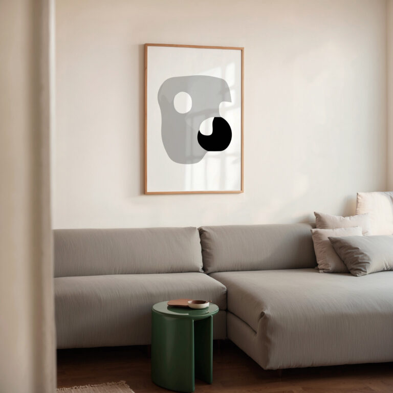 Abstract geometric print above gray sectional sofa with green accent table.