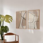 Minimalist abstract line art prints with monstera plant in modern interior setting.