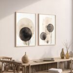 Elegant abstract watercolor prints in black and beige with modern console table display.