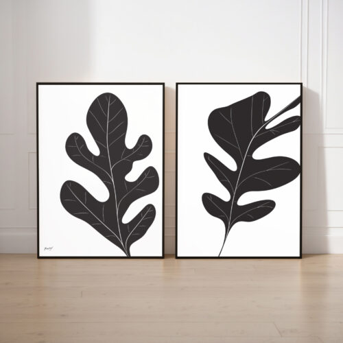 Minimalist black leaf silhouettes in elegant frames against white wall, modern botanical decor.
