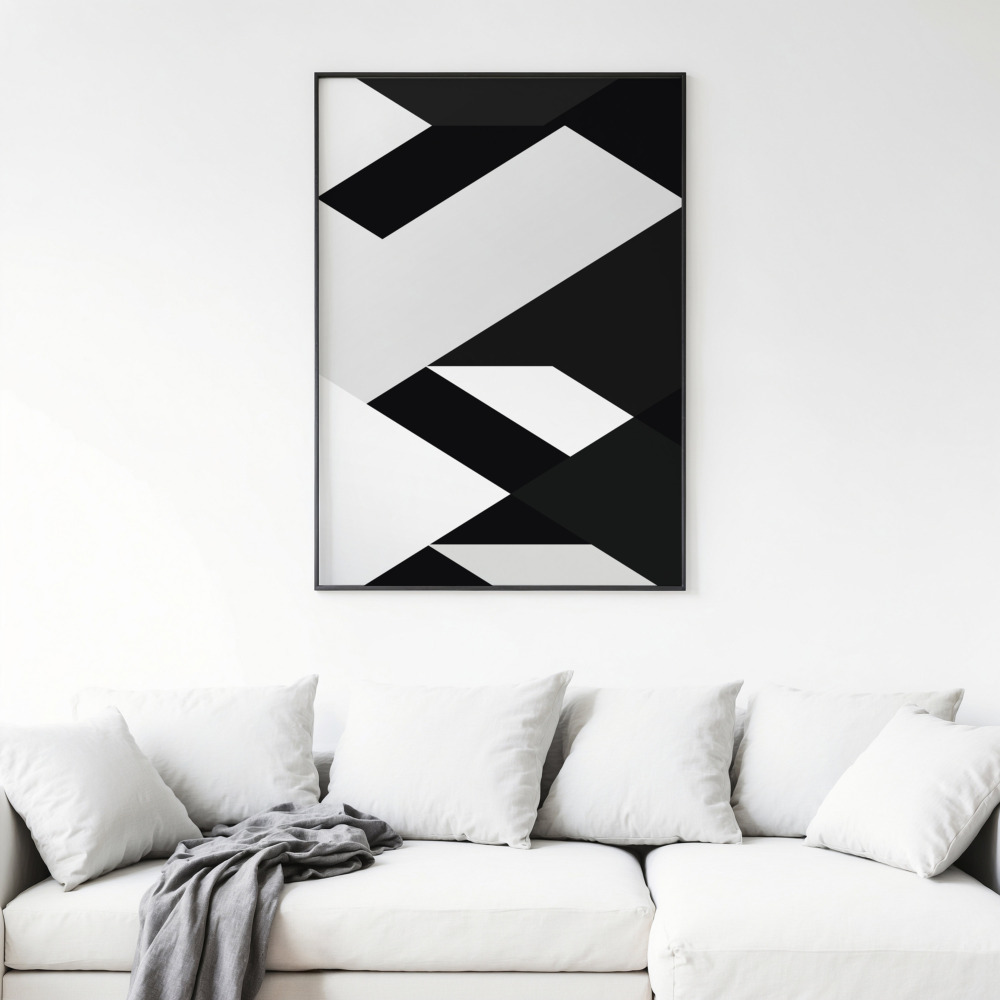 Bold geometric black and white abstract art print above white sofa with cushions