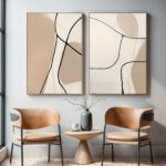 Minimalist abstract diptych with caramel leather chairs and small accent table