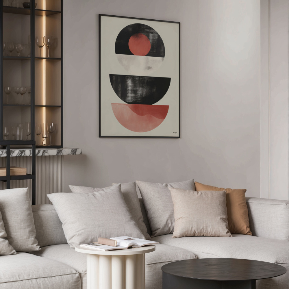 Geometric abstract artwork with black and red shapes above neutral sectional sofa.