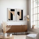 Modern minimalist living room with geometric art prints above wooden credenza.