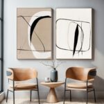 Minimalist abstract wall art with mid-century chairs and round gold accent table