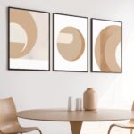 Minimalist abstract circle art prints with light wood table in Scandinavian interior design.
