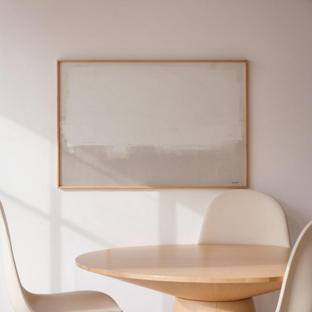 Minimalist abstract wall art in neutral beige tones above wooden round table