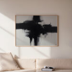 Bold black brushstroke painting above cream sofa in minimalist living room.