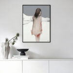 Minimalist Nordic abstract figure art in soft watercolors with black frame on white wall.