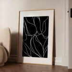 Minimalist black and white abstract floral art with flowing lines in wooden frame.