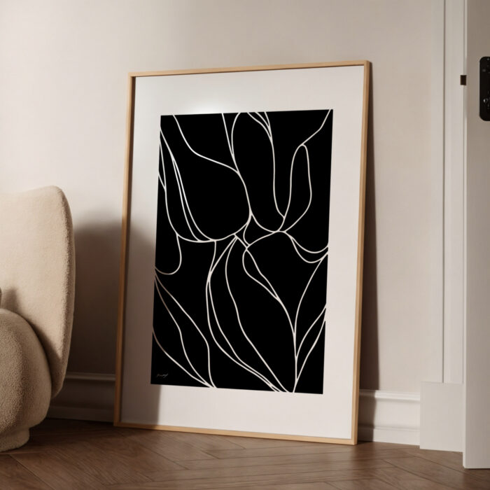 Minimalist black and white abstract floral art with flowing lines in wooden frame.