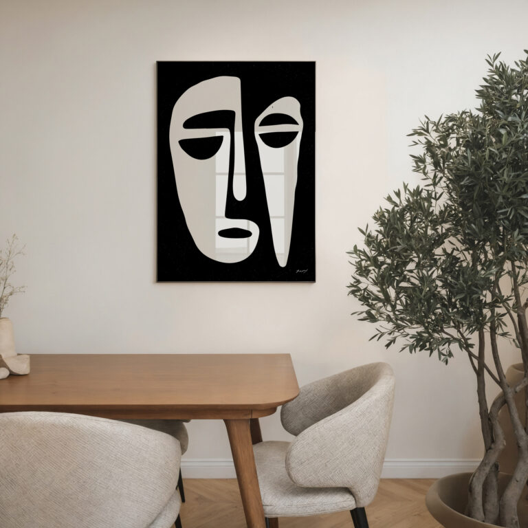 Minimalist black and white face artwork above wooden table in modern Scandinavian interior setting.